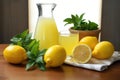 bundle of organic lemons, a lemon squeezer, and squeezed juice in a glass Royalty Free Stock Photo