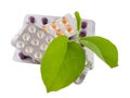 Bundle of pills with green leaves.