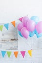 bundle of pink and blue balloons in room, baby shower