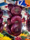 Bundle of red Crimean onion hanging over the counter market