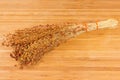 Bundle of the ripe sorghum on a wooden surface