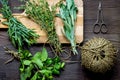 Bundle of sage and thyme on wooden board top view