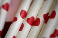 Bundle of straws with printed hearts. Royalty Free Stock Photo