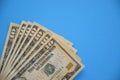 Bundle of ten dollar bills banknotes on blue background Royalty Free Stock Photo