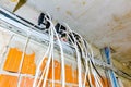 Bundle of various cables are hanging from above in indoor of building site Royalty Free Stock Photo