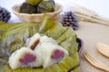 bundled boiled rice.banana and sticky rice wrapped in banana leaves and black bean paste on dish green leaf background.Thai food Royalty Free Stock Photo