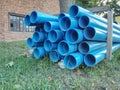 Bundles of blue plastic pipes for water transport. Pipe batch Royalty Free Stock Photo