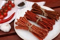 Bundles of delicious kabanosy and different products on wooden table