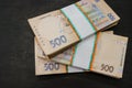 Bundles of hryvnia on a black background. Ukrainian money. 500 hryvnia banknotes. A lot of Ukrainian money. Stacks of hryvnia on t