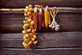 Bundles of onions, corn and garlic hang against the log wall