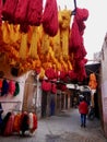Bundles of orange and red wool hanging to dry at dyers souk, Marrakech, Morocco.