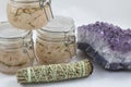 Bundles of Sage with amethyst and jars of beauty product