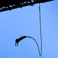 Bungee jumper against blue sky