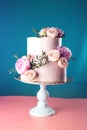Pink cream wedding cake decorated with fresh roses Royalty Free Stock Photo