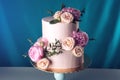 Pink cream wedding cake decorated with fresh roses Royalty Free Stock Photo