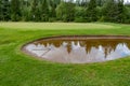 Bunker full of water on a golf course Royalty Free Stock Photo
