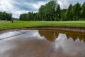 Bunker full of water on a golf course Royalty Free Stock Photo