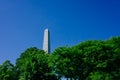 Bunker Hill Monument, an oblisk to commemorate the Battle of Bunker Hill, over green trees and blue sky, in Charlestown, Boston, Royalty Free Stock Photo