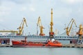 Bunker ship (fuel replenishment tanker) under port crane Royalty Free Stock Photo