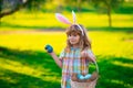 Bunny boy. Easter bunny children. Kids boy in bunny ears hunting easter eggs in park outdoor.