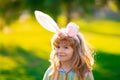 Bunny child boy face. Easter bunny children. Kids boy in bunny ears in park outdoor.