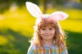 Bunny child boy face. Kids boy in bunny ears outdoor. Child having easter in park.