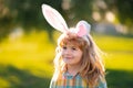 Bunny child boy face. Kids boy hunting easter eggs. Child in bunny ears hunt Easter eggs.