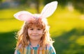 Bunny child boy face. Kids boy in bunny ears outdoor. Child having easter in park.