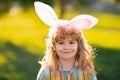 Bunny child boy face. Child boy in rabbit costume with bunny ears in park.