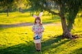 Bunny child. Child boy in rabbit costume with bunny ears hunting easter eggs in park.