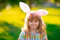 Bunny child. Child boy hunting easter eggs. Child boy with easter eggs and bunny ears in park.