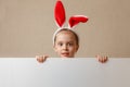 Beautiful little girl with bunny ears and blank banner