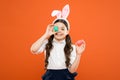Bunny is coming. small girl wear bunny ears. little kid in rabbit costume. spring holiday celebration. Easter eggs and