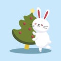 Bunny decorating christmas tree isolated. Merry Christmas and Happy New Year. Winter character with decorations. Cute Royalty Free Stock Photo