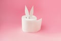 Bunny ears out of white toilet paper roll on pastel pink background. Easter coronavirus trendy rabbit concept. Side view Royalty Free Stock Photo