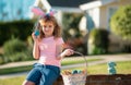 Bunny easter child. Kids hunting easter eggs. Boy with easter eggs and bunny ears in backyard.