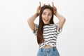 Bunny is girls spirit animal. Portrait of cute playful european woman in casual outfit, looking aside and making faces Royalty Free Stock Photo