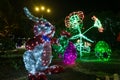Bunny made of tinsel and garlands in the dark of the night. Easter symbol. Urban scenery during the celebration
