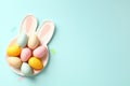 Bunny shaped plate with colorful Easter eggs on blue background. Happy Easter greeting card design Royalty Free Stock Photo