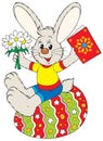 Bunny sits on the Easter egg Royalty Free Stock Photo