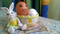 Bunny toy with easter eggs and paper dollars