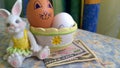 Bunny toy with easter eggs and paper dollars