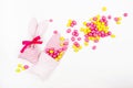 Bunny treat bags with pink and yellow candies on white background