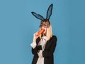 Bunny woman with carrot. Easter rabbit girl with black ears.