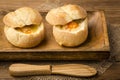 Buns baked with eggs and cheese on the wooden background. Royalty Free Stock Photo