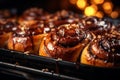 buns with caramel and nuts on a baking sheet