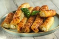 Buns with cheese or cottage cheese made from puff pastry on a plate. Close-up, selective focus natural light Royalty Free Stock Photo