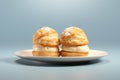 Buns with cream in a plate on a blue background. AI generative
