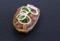 Buns with minced pork sausage, german mettwurst with onions and parsley garnish on a breakfast table with a slate board Royalty Free Stock Photo