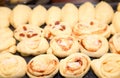 Buns with raisin and cinnamon before baking, a fragment of a big Royalty Free Stock Photo